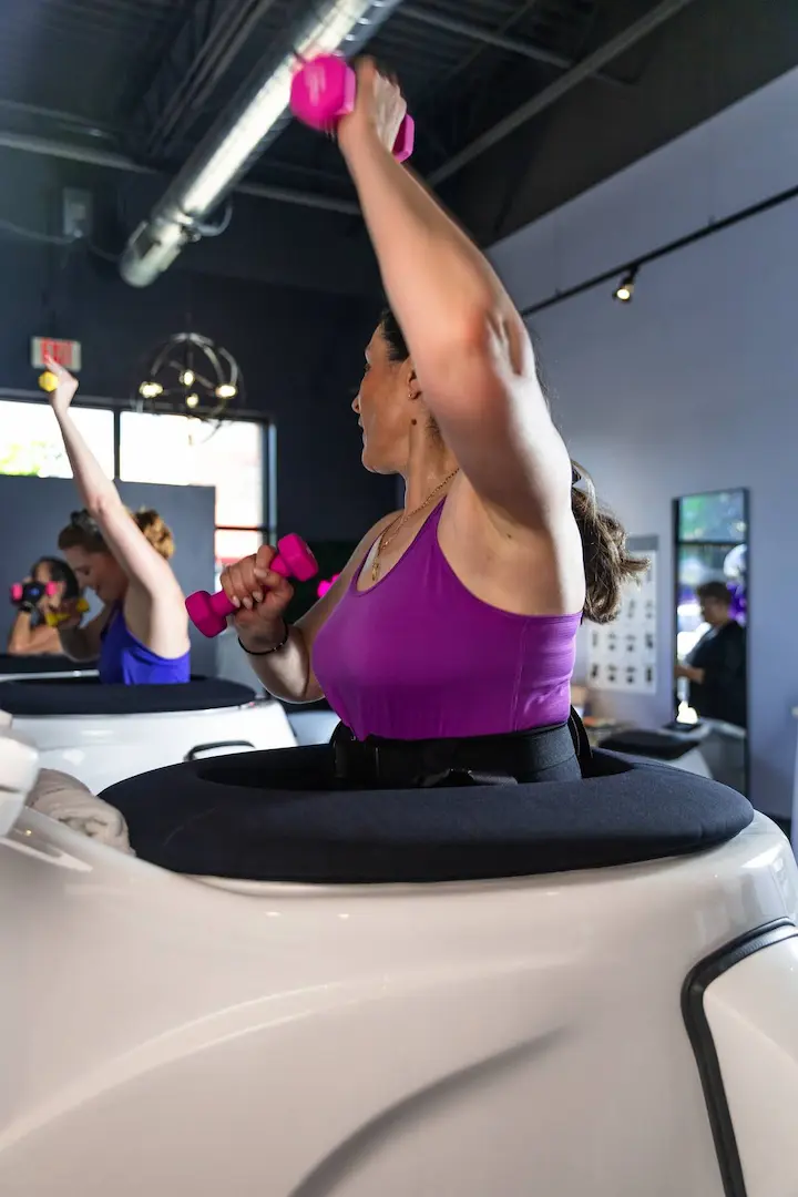 Women training with dumbbells inside the VacuTherm pods at Lux Body Space